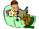 Man smiling as he reads in an armchair